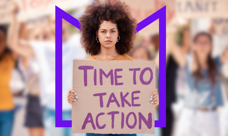 A Black woman holding a cardboard sign reading "Time to take action"